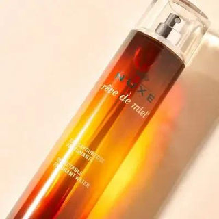 Nuxe Reve De Miel Body Spray - 3.38 fl oz, Orange Blossom & Sandalwood Fragrance for Women Nuxe Reve De Miel Body Spray - Orange Blossom & Sandalwood Nuxe Reve De Miel, Body Spray, Fragrance, Perfume Spray, Orange Blossom, Sandalwood, Tonka Bean, Women's Fragrance, Long Lasting Scent, Floral Fragrance, Woody Fragrance, Luxurious Fragrance, Daily Skincare, Confidence Boost, Romantic Gift, Everyday Fragrance