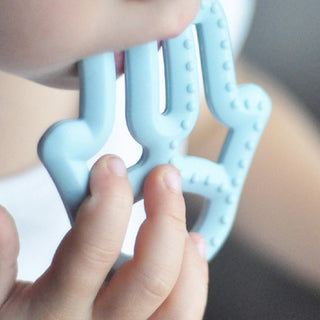 OiOi Baby Silicone Teether - Mineral Blue, Safe & Effective Teething Relief for Infants OiOi Baby Silicone Teether - Safe Teething Relief baby teether, silicone teether, teething relief for infants, non-toxic baby products, baby oral care, safe teething toys, OiOi, baby products, teething solutions, infant care, baby safety, durable teether, easy to clean teether, fine motor skills development