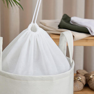 coco foldable felt laundry basket, white felt laundry basket with orange drawstring, foldable felt laundry basket in home setting Coco Foldable Felt Laundry Basket - Chic Design for Organizers | 14 in x 20 in Coco Foldable Felt Laundry Basket coco, foldable-basket, laundry-basket, felt-basket, home-organization, storage-solution, machine-washable, stylish-storage, toys-storage, ai-generated