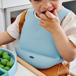 oi oi premium silicone bib mineral blue, oi oi bib for babies 6 months to 4 years OiOi Premium Silicone Bib - Mineral Blue for Babies & Toddlers | 6 Months to 4 Years OiOi Mineral Blue Bib for Babies - Premium Silicone oi oi, bib, silicone bib, baby feeding, parents, caregivers, mealtime, toddler accessories, premium silicone, ai-generated