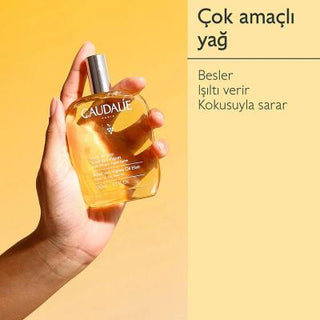 caudalie soleil des vignes elixir oil bottle, application of caudalie elixir oil on skin Caudalie Soleil des Vignes Elixir Oil - Nourishing | 50 ml Caudalie Soleil des Vignes Elixir Oil - Nourishing | 50 ml caudalie, body-oil, vegan, skincare, nourishing-oil, hydrating, summer-scent, non-greasy, natural-beauty, ai-generated